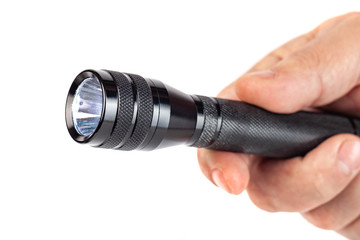 Hand holding flashlight on white background