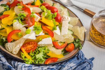 Salad with cheese and fresh vegetables.