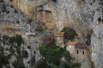 ruins of old monastery clinging to the rock side