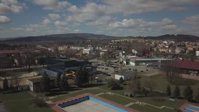 Gorlice, Poland - 3 9 2019: Panorama of the historic center of the European medieval city on the picturesque green hills. Trips to architectural monuments, temples, quarters and sports complex MOSiR