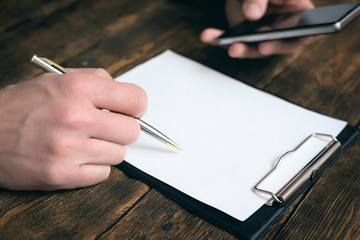 Agreement or business contract template. To do list mock up. Blank paper sheet. Businessman is...
