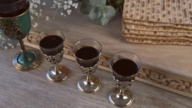 Red kosher four glasses wine with a of matzah a Passover Haggadah
