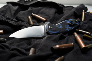 Knife ammunition on a black background. Military sleeves and knife.