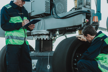 Serious workers having job in the airport