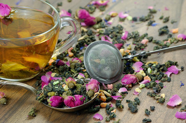 green tea. cup of green tea with flowers and fruit pieces. blend tea