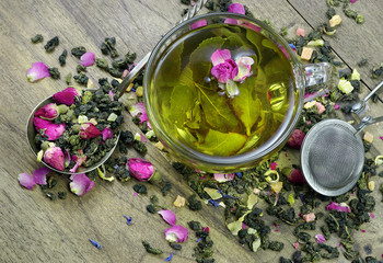 green tea. cup of green tea with flowers and fruit pieces. blend tea