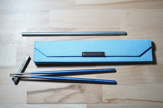Helsinki, Finland - March 27, 2019: Chopsticks and straw made of titanium for sustainable purposes and not using plastic ones. Shot as macro shot with filling flash light.
