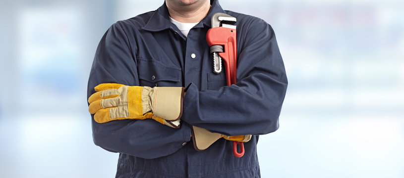 Plumber hand with wrench.