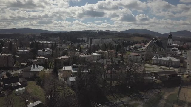 Gorlice, Poland - 3 9 2019: Panorama of the historic center of the European medieval city on the picturesque green hills. Trips to architectural monuments, temples, quarters and sports complex MOSiR