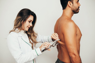 Female sports nutritionist attending patient in her clinic