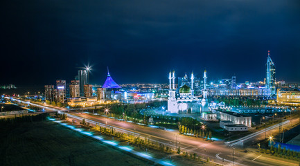 Fototapeta na wymiar Mosque Nur-Astana and Khan-Shatyr in night illumination, panoramic top view, Kazakhstan, Astana Nur-Sultan