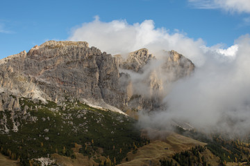 The Cirspitzen, Cime Cir, covered in clouds while the Sky is Blue. The Dolomites in Fall