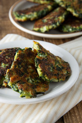 Fried vegetarian broccoli and spinach fritties, for burgers on a wooden table. Vegetarian and healthy food.