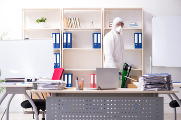 Professional contractor doing pest control at office 