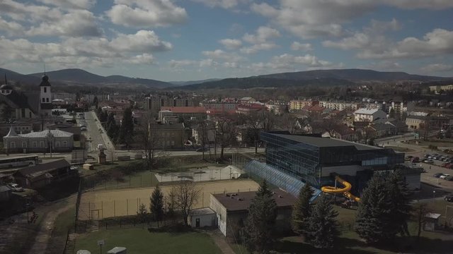 Gorlice, Poland - 3 9 2019: Panorama of the historic center of the European medieval city on the picturesque green hills. Trips to architectural monuments, temples, quarters and sports complex MOSiR