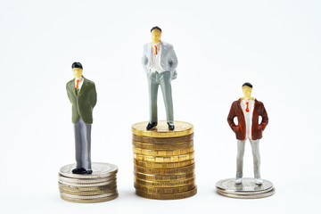 miniature figures of people standing on the pedestals of the winners of the coins