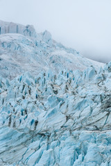 Glacial blues and dirt browns in fractured ice patterns on glacier in Drygalski Fjord, South Georgia, as a nature background
