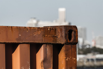 It is a rusty fence of the port.
