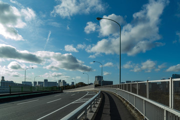It is a road where the blue sky and the car are not running