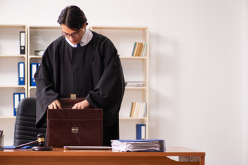 Young handsome judge working in court 