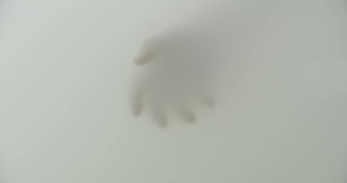 Creepy hand appearing out of a cloudy mist