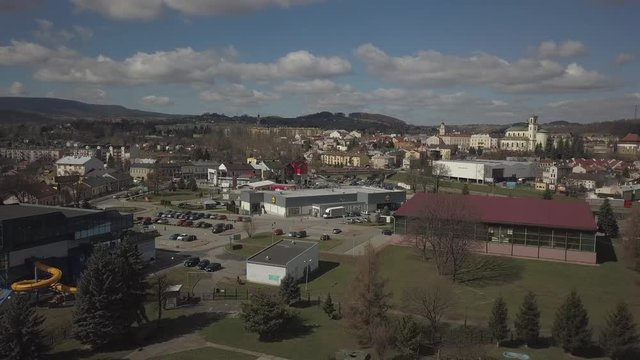 Gorlice, Poland - 3 9 2019: Panorama of the historic center of the European medieval city on the picturesque green hills. Trips to architectural monuments, temples, quarters and sports complex MOSiR