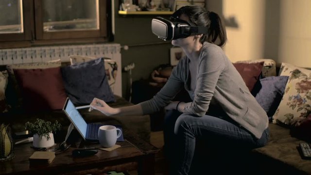 Woman working with virtual reality headset at smart home