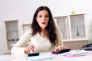 Young woman with receipts in budget planning concept 