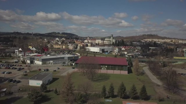 Gorlice, Poland - 3 9 2019: Panorama of the historic center of the European medieval city on the picturesque green hills. Trips to architectural monuments, temples, quarters and sports complex MOSiR