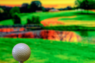 Close up photo of a golf ball in the golf course in a warm sunset light