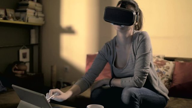 Girl working with virtual reality headset at smart home