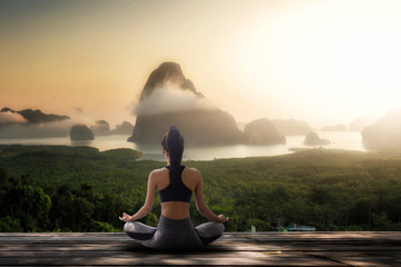 young women meditate while doing yoga in the morning