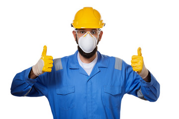 Builder in hard hat in mask and transparent safety glasses raising his thumbs up in working gloves,...