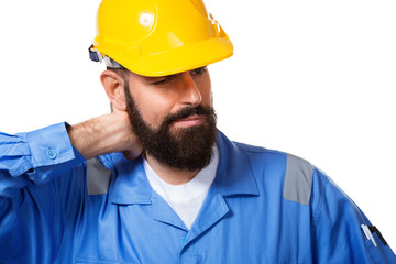 Bearded constructor or builder or foreman in the yellow helmet suffering neck pain. Health insurance concept. Isolated over white background