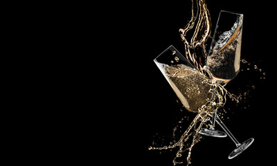 Glasses of champagne clinking together and splashing on black background © New Africa