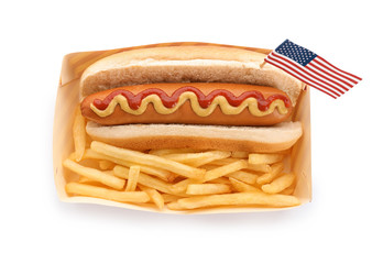Hot dog with USA flag and French fries in paper box on white background, top view. Traditional American food