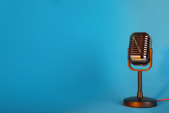 Retro microphone on color background. Space for text