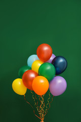 Fototapeta na wymiar Bunch of bright balloons on color background. Celebration time