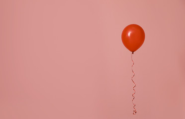 Bright balloon on color background, space for text. Celebration time