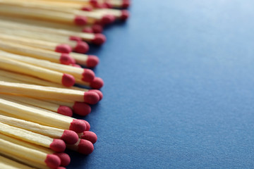 Many matches on color background, closeup. Space for text