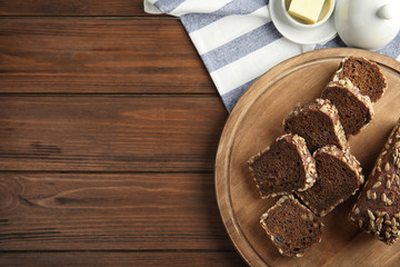 Tasty rye bread on wooden table, top view. Space for text