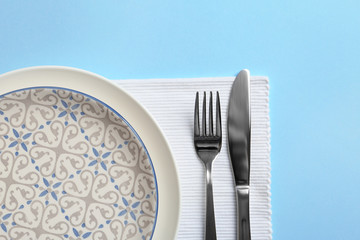 Stylish elegant table setting on color background, top view