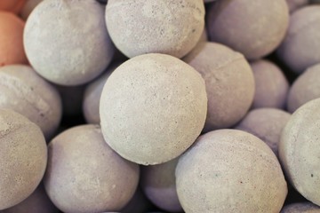 Close up photo of a stack of large, tan bath bombs at a wellness spa