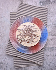 Delicious cake with milky glaze and chocolate decor. Top view. Delicacy. Gray background. Striped serviette.