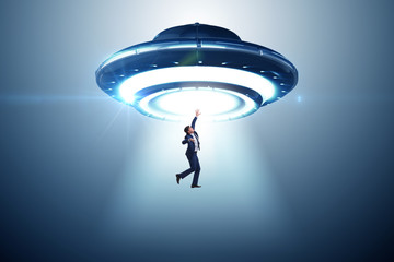 Flying saucer abducting young businessman 