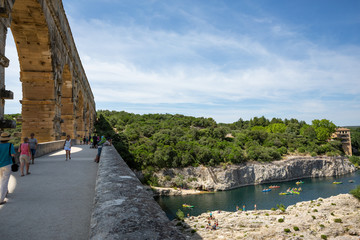 Fototapeta premium Gard, France July 13th 2015 : The magnificent three tiered Pont Du Gard aqueduct was constructed by Roman engineers in the 1st century AD in the south of France