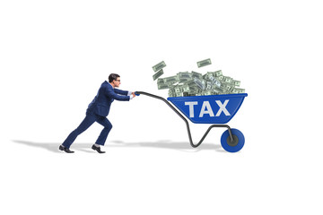 Businessman pushing wheelbarrow full of money in tax concept