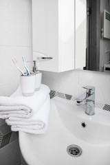 Bathroom, body care products and towel . Bath preparation. White interior of bathroom. Shampoo, shower gel and other bathing accessories. Toothbrush and soap dispenser. details of bathroom 