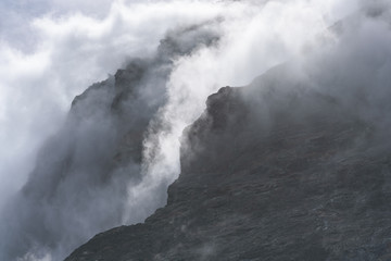 Dramatic fog shrouded rock face as a nature background, Drygalski Fjord, South Georgia