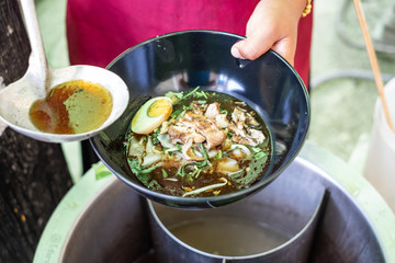 Chef cooking a delicious paste of rice flour. Thai food menu recipe.